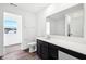 Bathroom with white countertop, brown cabinets, and a toilet, offering a view through the door into another room at 1585 N Regatta Dr, Greenfield, IN 46140
