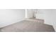 A well lit bedroom featuring neutral carpeting, multiple doorways, and modern white paint at 1585 N Regatta Dr, Greenfield, IN 46140
