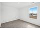 Sunlit bedroom with neutral carpet, two windows, and a view of the neighborhood landscape at 1585 N Regatta Dr, Greenfield, IN 46140