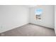 A simple bedroom, featuring carpet and natural light from the single window at 1585 N Regatta Dr, Greenfield, IN 46140
