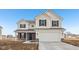 Charming two-story home featuring light siding, black shutters, and an attached two-car garage at 1585 N Regatta Dr, Greenfield, IN 46140
