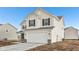 Attractive two-story home showcasing light siding, black shutters, and an attached two-car garage at 1585 N Regatta Dr, Greenfield, IN 46140