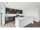 Kitchen boasts dark cabinets, stainless steel appliances, and granite countertops at 1585 N Regatta Dr, Greenfield, IN 46140