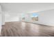 Bright living room showcasing stylish wood-look flooring and plenty of natural light from large windows at 1585 N Regatta Dr, Greenfield, IN 46140