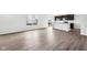 Bright living room featuring elegant wood-look flooring and a glimpse of the modern kitchen at 1585 N Regatta Dr, Greenfield, IN 46140