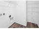 Functional walk-in closet with wire shelving and visible hookups for a washer and dryer at 1585 N Regatta Dr, Greenfield, IN 46140