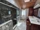 Updated bathroom with a glass-enclosed shower, dual sinks, and tiled flooring at 16575 Audubon Ct, Noblesville, IN 46060