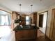 Kitchen with central island, wood cabinets, stainless steel appliances, and hardwood flooring at 16575 Audubon Ct, Noblesville, IN 46060