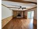 Cozy living room features a brick fireplace, wood-paneled walls, built-in shelving, and hardwood floors at 16575 Audubon Ct, Noblesville, IN 46060