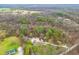 An aerial view of a charming home nestled in a lush wooded area with mature trees at 1794 Bell Rd, Morgantown, IN 46160