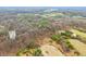 High-angle view revealing a mosaic of trees, fields, and ponds, showcasing the diverse environmental features of the land at 1794 Bell Rd, Morgantown, IN 46160