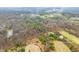 Aerial view of land featuring a mix of woodlands, open fields, and early blossoms, hinting at the arrival of spring at 1794 Bell Rd, Morgantown, IN 46160