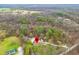 An aerial view of a charming home nestled in a lush wooded area with mature trees at 1794 Bell Rd, Morgantown, IN 46160