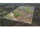 An elevated view of property boundaries, displaying a mix of wooded areas and residential buildings within the parcel at 1794 Bell Rd, Morgantown, IN 46160