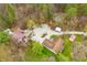 Aerial view of home with large backyard, sheds, and barn nestled amongst trees at 1794 Bell Rd, Morgantown, IN 46160
