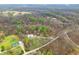 Overhead shot displaying a densely wooded lot with visible homes and structures nestled throughout the landscape at 1794 Bell Rd, Morgantown, IN 46160