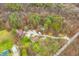 A tranquil aerial view of a home surrounded by dense forest, showcasing its secluded setting at 1794 Bell Rd, Morgantown, IN 46160