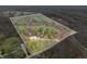 Expansive aerial view of a wooded property with a defined boundary line, showcasing its natural surroundings and potential at 1794 Bell Rd, Morgantown, IN 46160