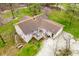 An aerial view of a backyard with a deck and table surrounded by lush landscaping at 1794 Bell Rd, Morgantown, IN 46160