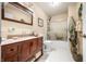 Bathroom with a wooden frame mirror, granite countertops, toilet, and shower with glass doors at 1794 Bell Rd, Morgantown, IN 46160