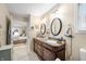 Bathroom featuring double sinks, granite countertops, and a shower-tub combo with glass doors at 1794 Bell Rd, Morgantown, IN 46160