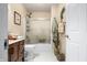 Bathroom with a wooden frame mirror, granite countertops, toilet, and shower with glass doors at 1794 Bell Rd, Morgantown, IN 46160