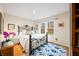 Bedroom with hardwood floors, a queen bed, and lots of natural light from large windows at 1794 Bell Rd, Morgantown, IN 46160