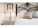 Close up of the bedding and nightstand. The headboard features a beautiful design, complemented by neutral bedding at 1794 Bell Rd, Morgantown, IN 46160