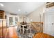 Bright dining room with hardwood floors, a modern rug, and a table for six with access to outdoor patio at 1794 Bell Rd, Morgantown, IN 46160