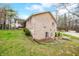 Brick home exterior features a basement walkout with stone landscaping and mature trees at 1794 Bell Rd, Morgantown, IN 46160