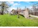 Brick home with a covered front porch, complemented by a sloping lawn and blossoming trees at 1794 Bell Rd, Morgantown, IN 46160