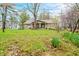 Charming brick home with a covered porch and a yard with mature trees and landscaping at 1794 Bell Rd, Morgantown, IN 46160