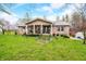 Charming brick home featuring a covered porch and a well-maintained front yard with mature trees and landscaping at 1794 Bell Rd, Morgantown, IN 46160