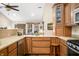 Open kitchen design with wooden cabinets, a peninsula, and stainless steel appliances at 1794 Bell Rd, Morgantown, IN 46160
