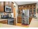 Spacious kitchen with stainless steel appliances, wood cabinets, and stone countertops at 1794 Bell Rd, Morgantown, IN 46160