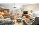 Inviting living room featuring a ceiling fan, multiple comfortable seating areas, and an open layout to the dining space at 1794 Bell Rd, Morgantown, IN 46160
