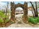 The property features a stone archway and walkway that leads to the house at 1794 Bell Rd, Morgantown, IN 46160