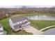 Aerial view of a two-story home with a pond, large yard, and three-car garage at 19477 Quilling Ln, Noblesville, IN 46062