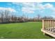 Large, well-maintained backyard with lush green grass and a view from the wooden deck at 19477 Quilling Ln, Noblesville, IN 46062