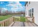 Beautiful backyard view from the wooden deck featuring a pond with fountain and well-manicured lawn at 19477 Quilling Ln, Noblesville, IN 46062