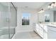 Bright bathroom showcasing a tub/shower combo, a window with natural light and vanity with double sinks at 19477 Quilling Ln, Noblesville, IN 46062