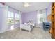 Comfortable bedroom showcasing lilac walls, carpeted floor, a unicorn stuffed animal, and natural light at 19477 Quilling Ln, Noblesville, IN 46062