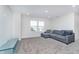 Cozy bonus room features a sectional sofa and ample natural light, perfect for a casual hangout at 19477 Quilling Ln, Noblesville, IN 46062