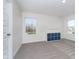 Bright bonus room with carpet floors, natural light, and storage shelving at 19477 Quilling Ln, Noblesville, IN 46062