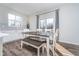 Bright dining room features a modern table with bench seating, light gray backsplash, and natural light at 19477 Quilling Ln, Noblesville, IN 46062