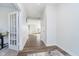 Bright hallway with wood floors and white trim, leading to an open living space at 19477 Quilling Ln, Noblesville, IN 46062