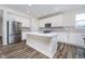 Open kitchen with a central island, stainless steel appliances, and ample counter space at 19477 Quilling Ln, Noblesville, IN 46062