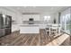 Modern kitchen featuring white cabinets, stainless steel appliances, and an island with bar seating at 19477 Quilling Ln, Noblesville, IN 46062