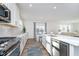 Stylish kitchen with white cabinets, quartz countertops, stainless steel appliances, and wood flooring at 19477 Quilling Ln, Noblesville, IN 46062