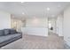 Open living area with comfortable sofa and ample space, leading to bedrooms and bathrooms at 19477 Quilling Ln, Noblesville, IN 46062